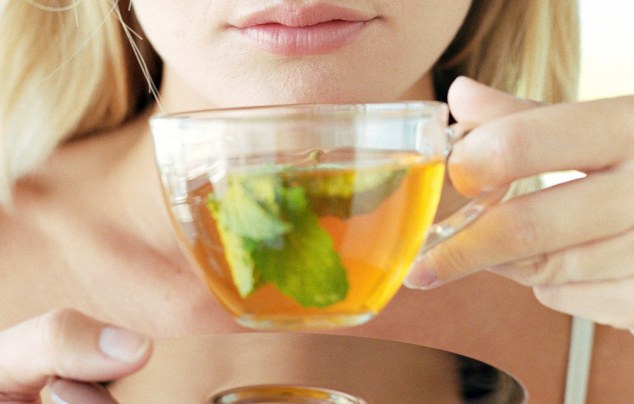 Picture of woman drinking herbal tea (green tea) from Alamy