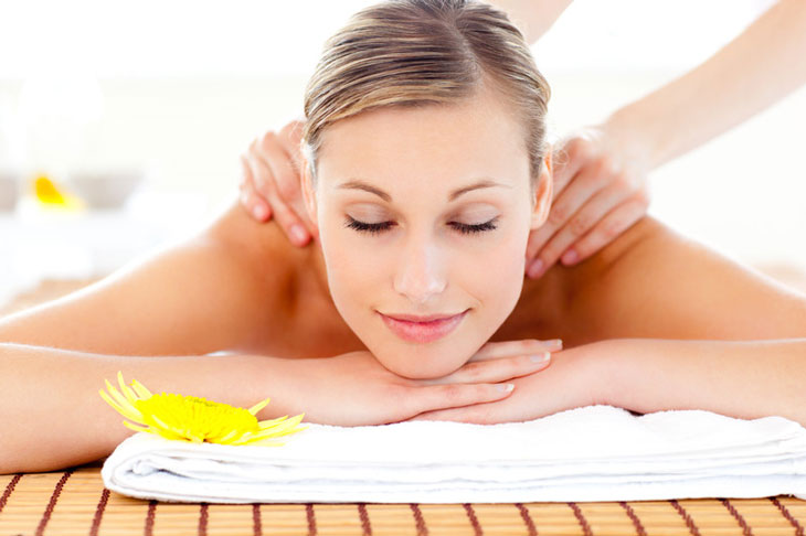 smiling-peaceful-woman-getting-back-massage